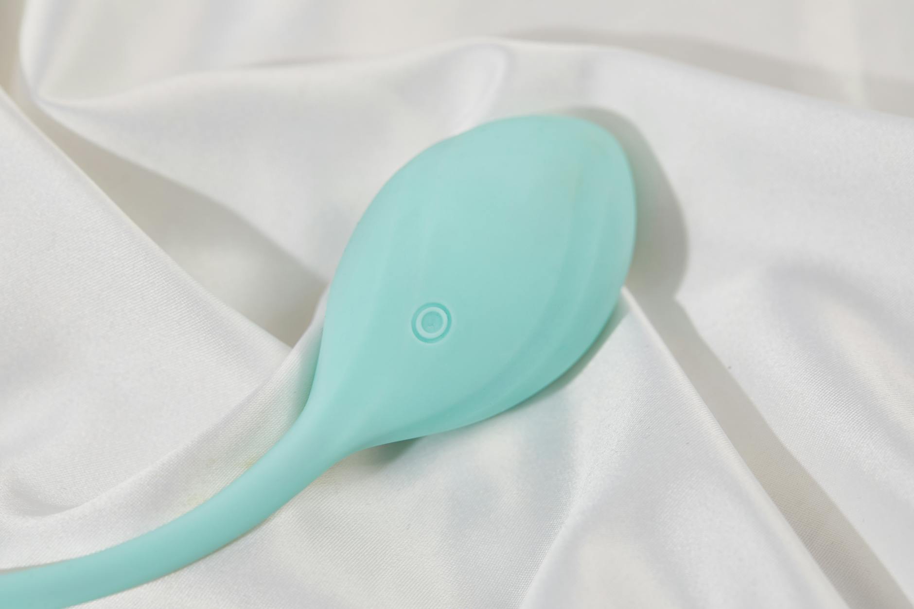 A couple standing together indoors, one holding a blue vibrator, symbolizing modern intimacy and communication