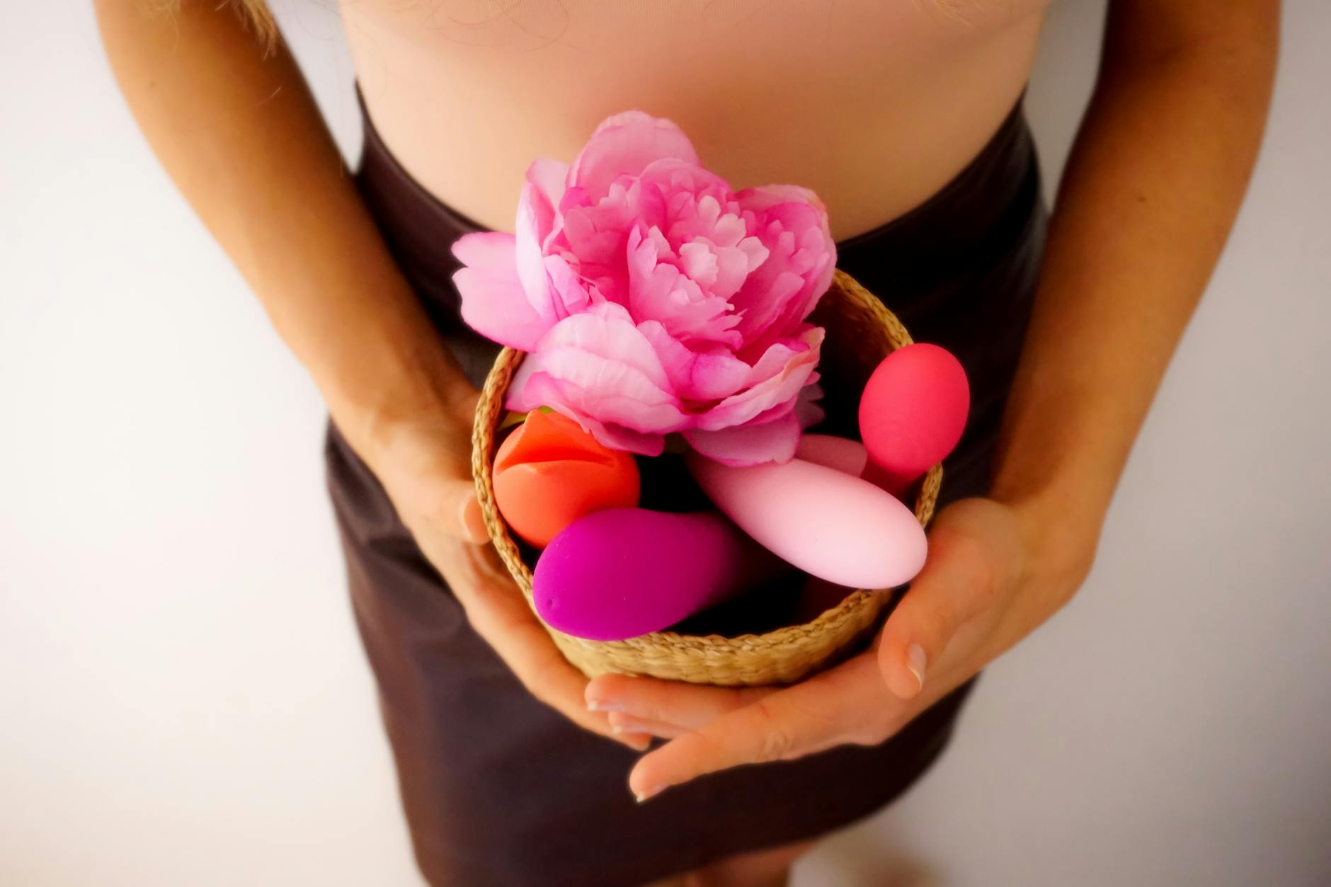 A basket of colorful vibrators and fresh flowers representing renewed pleasure and desire